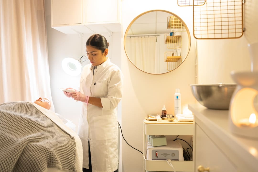 Kosmetologi Ligia Väisänen tekee hoitoa asiakkaalle Helsinki Beauty Labin hoitohuoneessa.